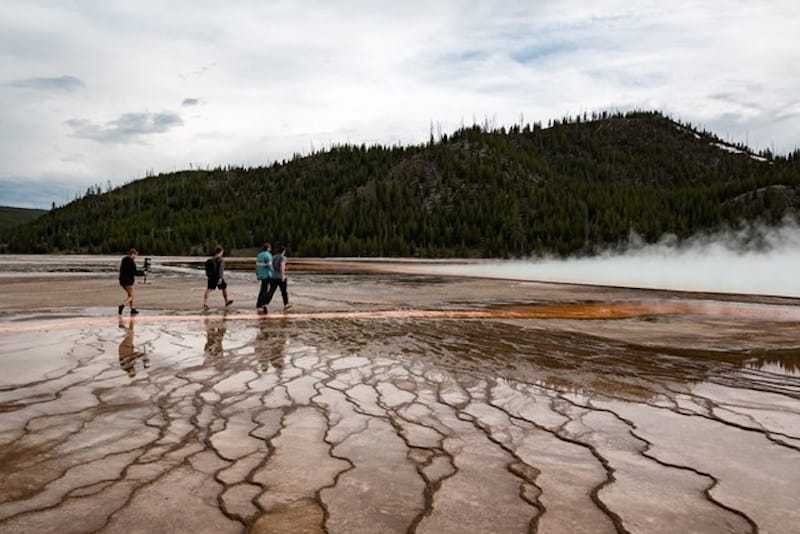 yellowstone tourists walking on hot springs